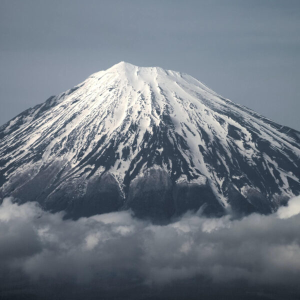mount fuji with clouds at the base