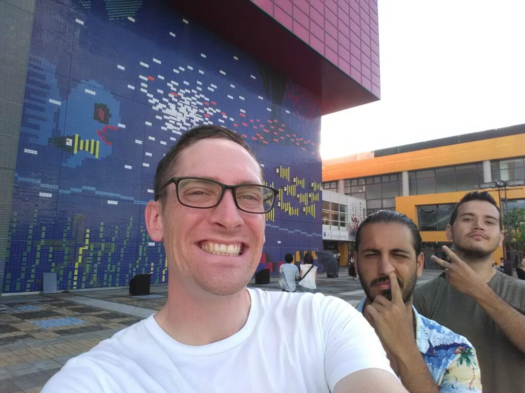 Three men standing in front of Osaka's aquarium
