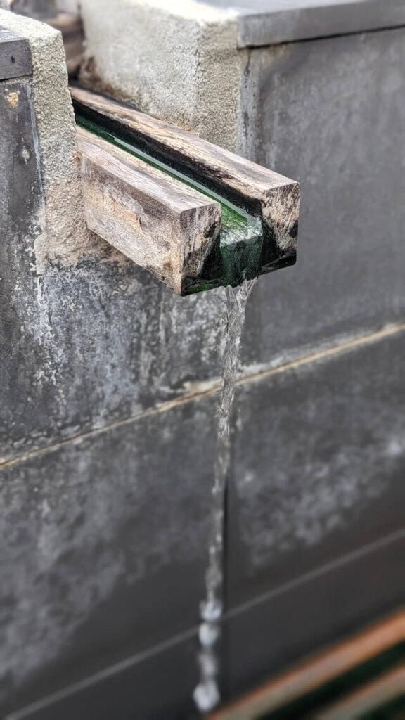 Natural hot water pouring from a spout at a Gunma onsen near Tokyo.